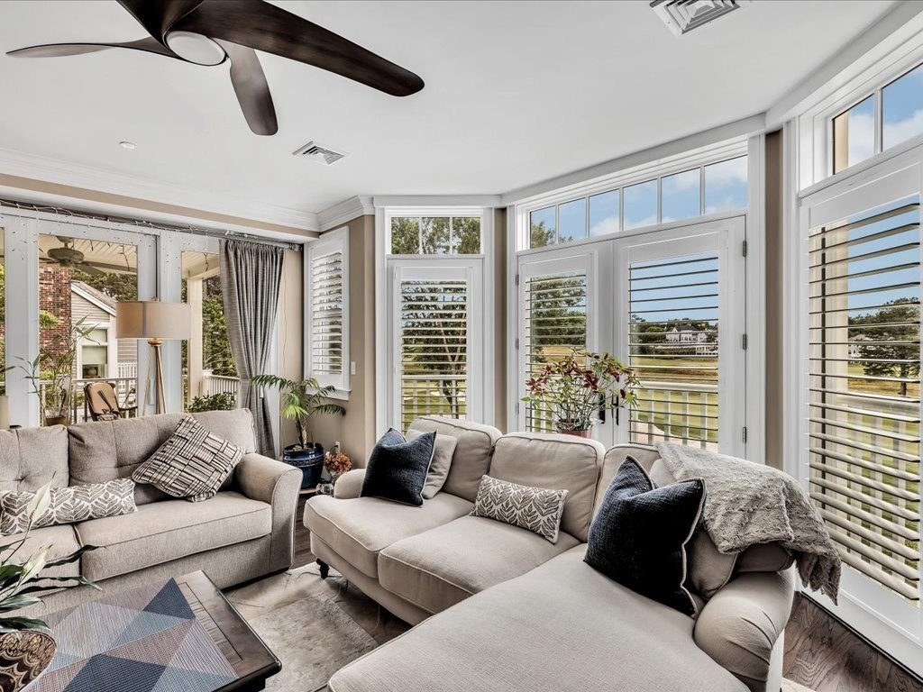 70 Simons Road, Unit C Mashpee, MA 02649 - Photo 9 of 23 a living room with furniture and floor to ceiling windows