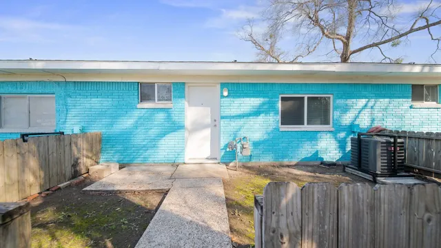 a view of a house with wooden fence