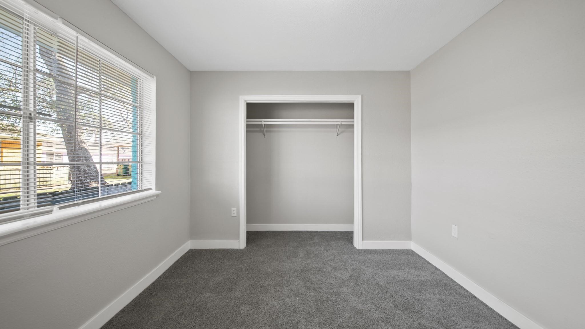 7810 Glass Street Houston, TX 77016 - Photo 7 of 12 an empty room with windows and closet
