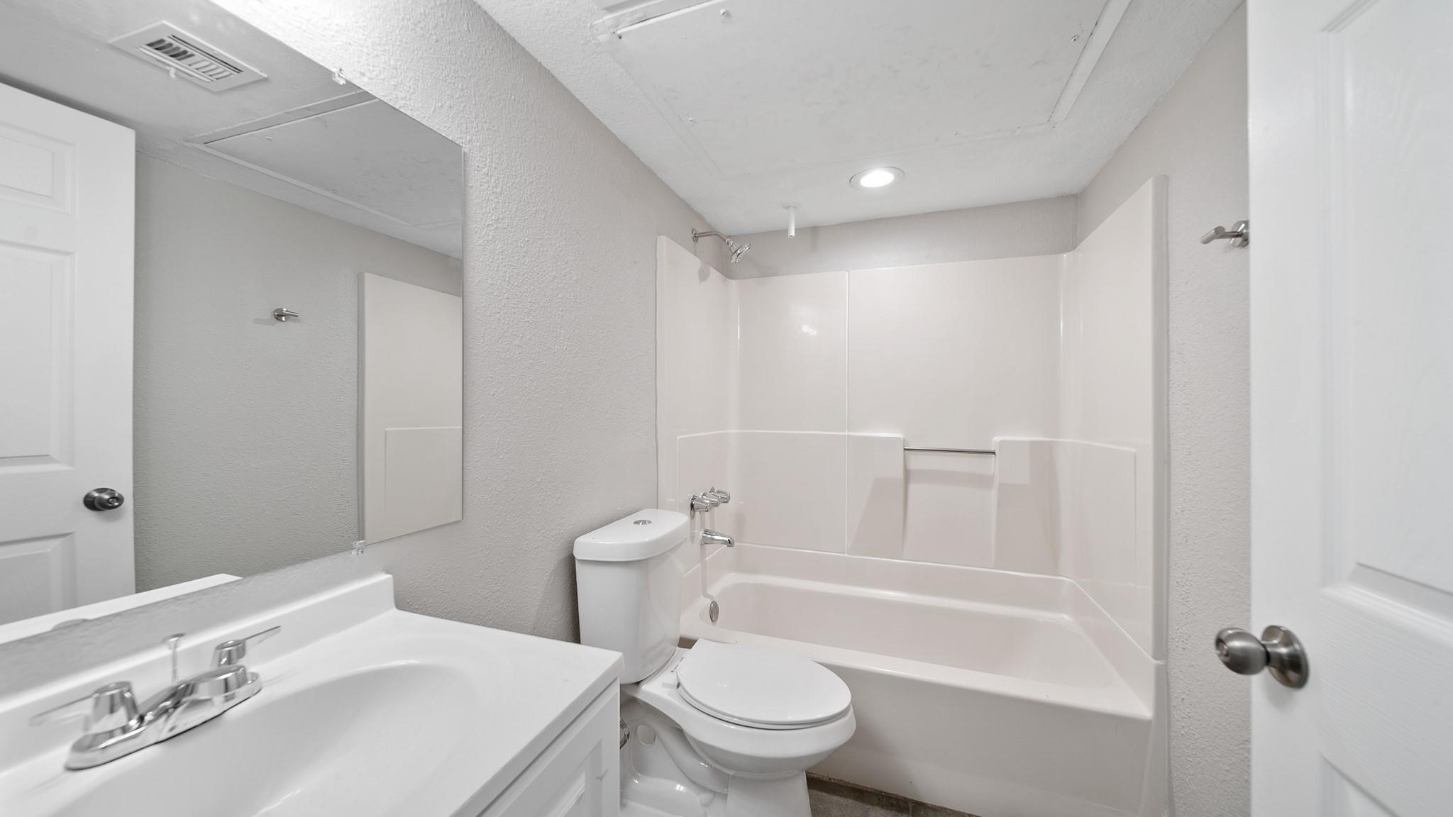 7810 Glass Street Houston, TX 77016 - Photo 8 of 12 a bathroom with a sink a toilet and shower