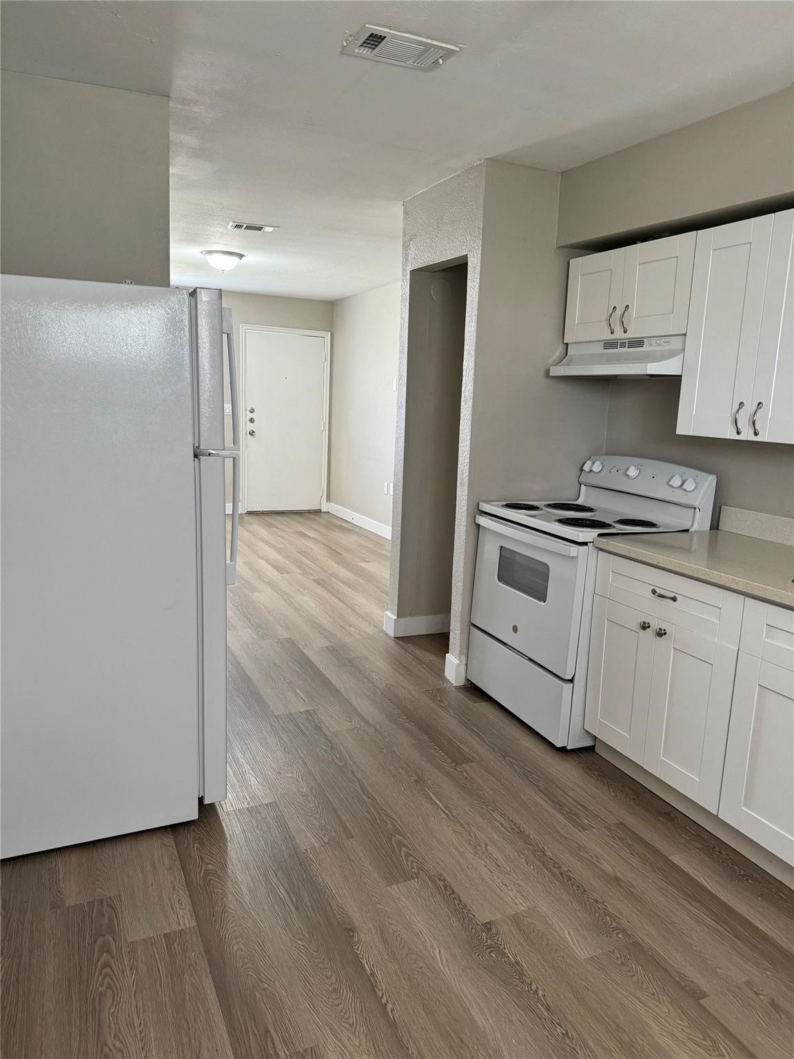 7810 Glass Street Houston, TX 77016 - Photo 10 of 12 a kitchen with stainless steel appliances a sink cabinets and wooden floor