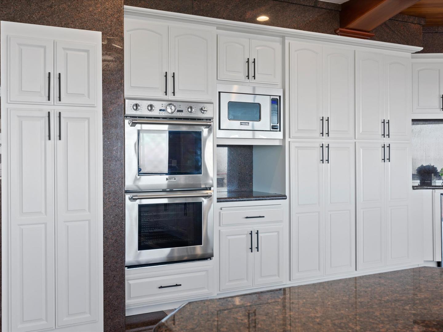 1 Lewis Ranch Road San Carlos, CA 94070 - Photo 31 of 94 a kitchen with stainless steel appliances white cabinets and white appliances