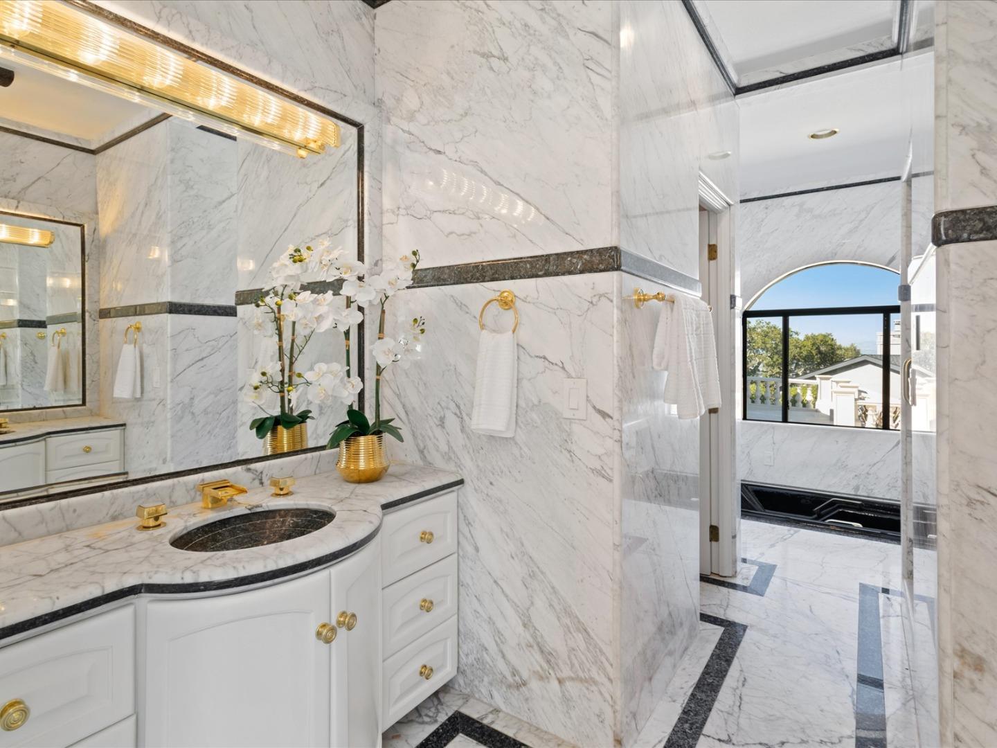 1 Lewis Ranch Road San Carlos, CA 94070 - Photo 50 of 94 a bathroom with a sink a mirror and shower