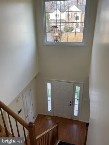 an empty room with a wooden floor and a window