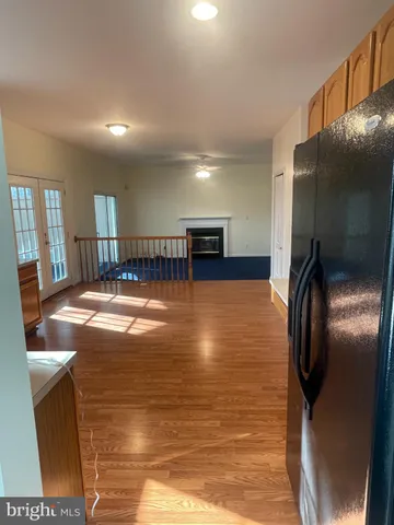 a view of a livingroom with furniture and chandelier fan