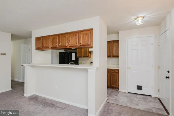 a kitchen with granite countertop a sink stove and cabinets