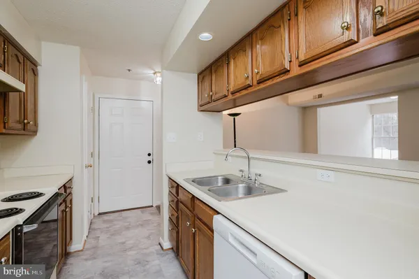 a kitchen with stainless steel appliances granite countertop a refrigerator stove and sink