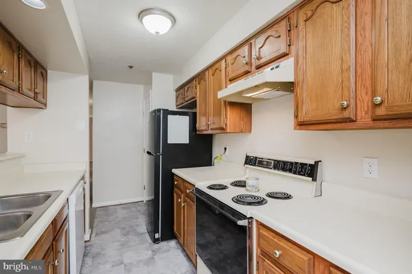 a kitchen with stainless steel appliances granite countertop a stove and a refrigerator