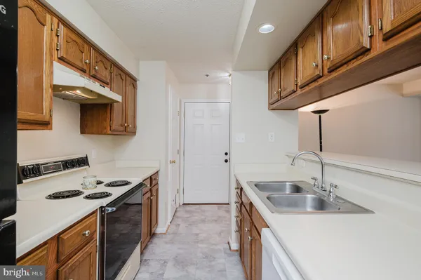 a kitchen with stainless steel appliances granite countertop a sink and a stove