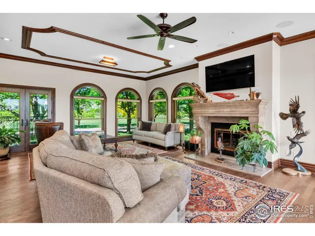 a living room with fireplace furniture and a flat screen tv