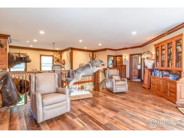 a living room with lots of furniture and painting on the wall