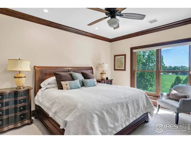 a bedroom with a large bed and a large window