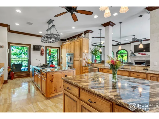a kitchen with stainless steel appliances granite countertop a sink window and cabinets