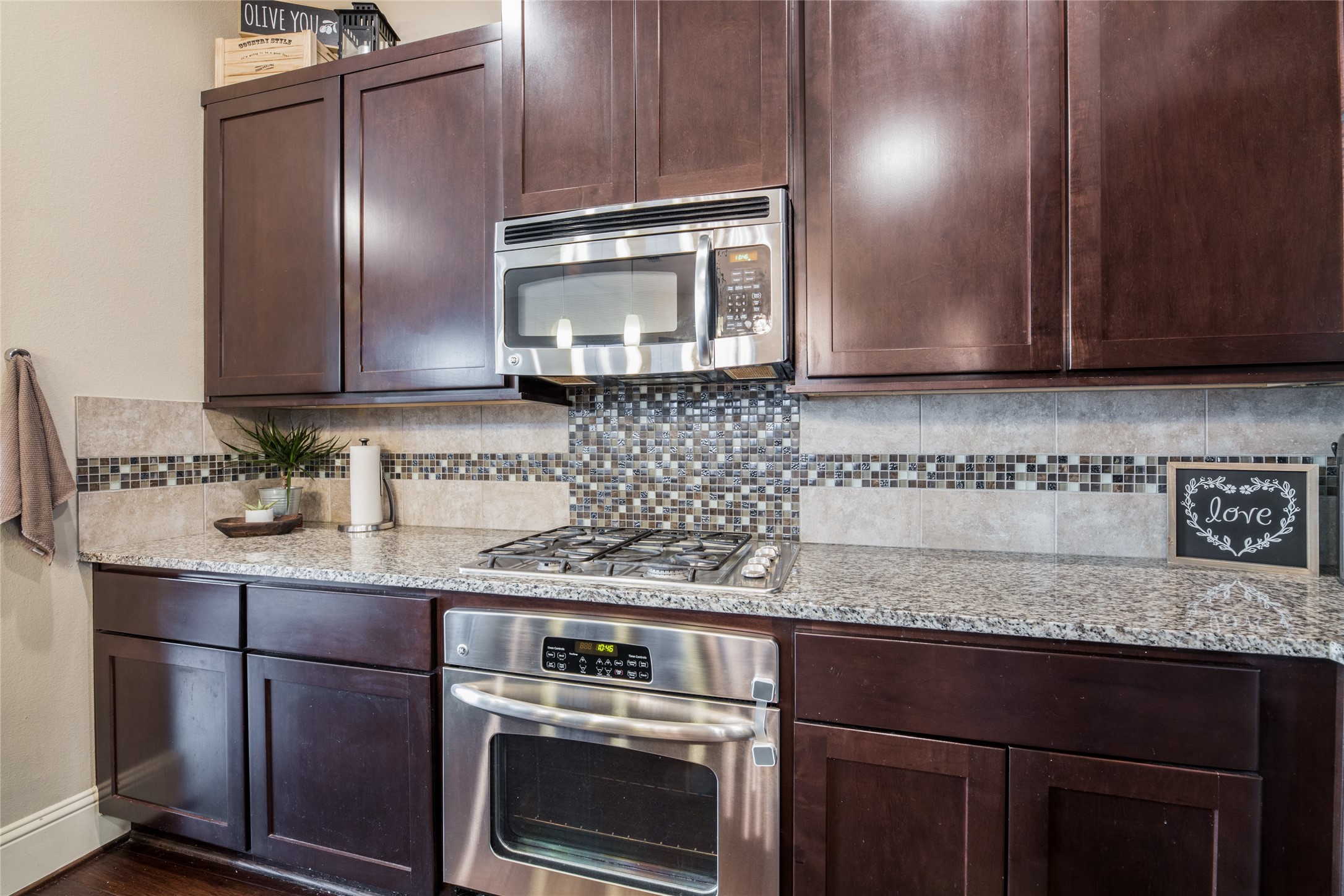769 Waverly Street Houston, TX 77007 - Photo 13 of 35 a kitchen with granite countertop stainless steel appliances wooden cabinets and a stove top oven