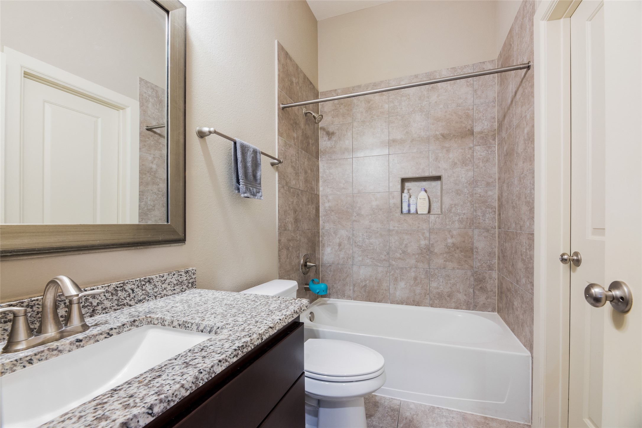 769 Waverly Street Houston, TX 77007 - Photo 19 of 35 a bathroom with a granite countertop sink toilet and shower