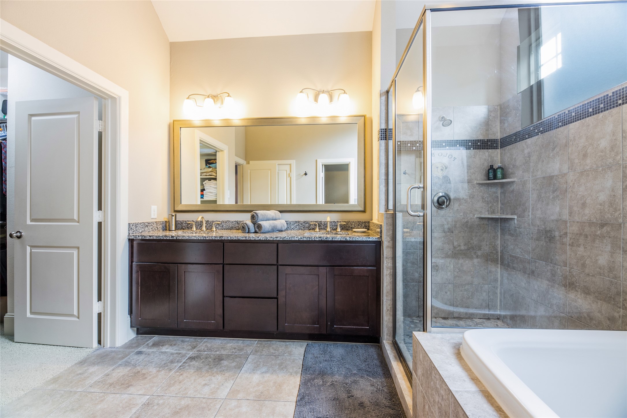 769 Waverly Street Houston, TX 77007 - Photo 23 of 35 a bathroom with a granite countertop sink mirror and bathtub