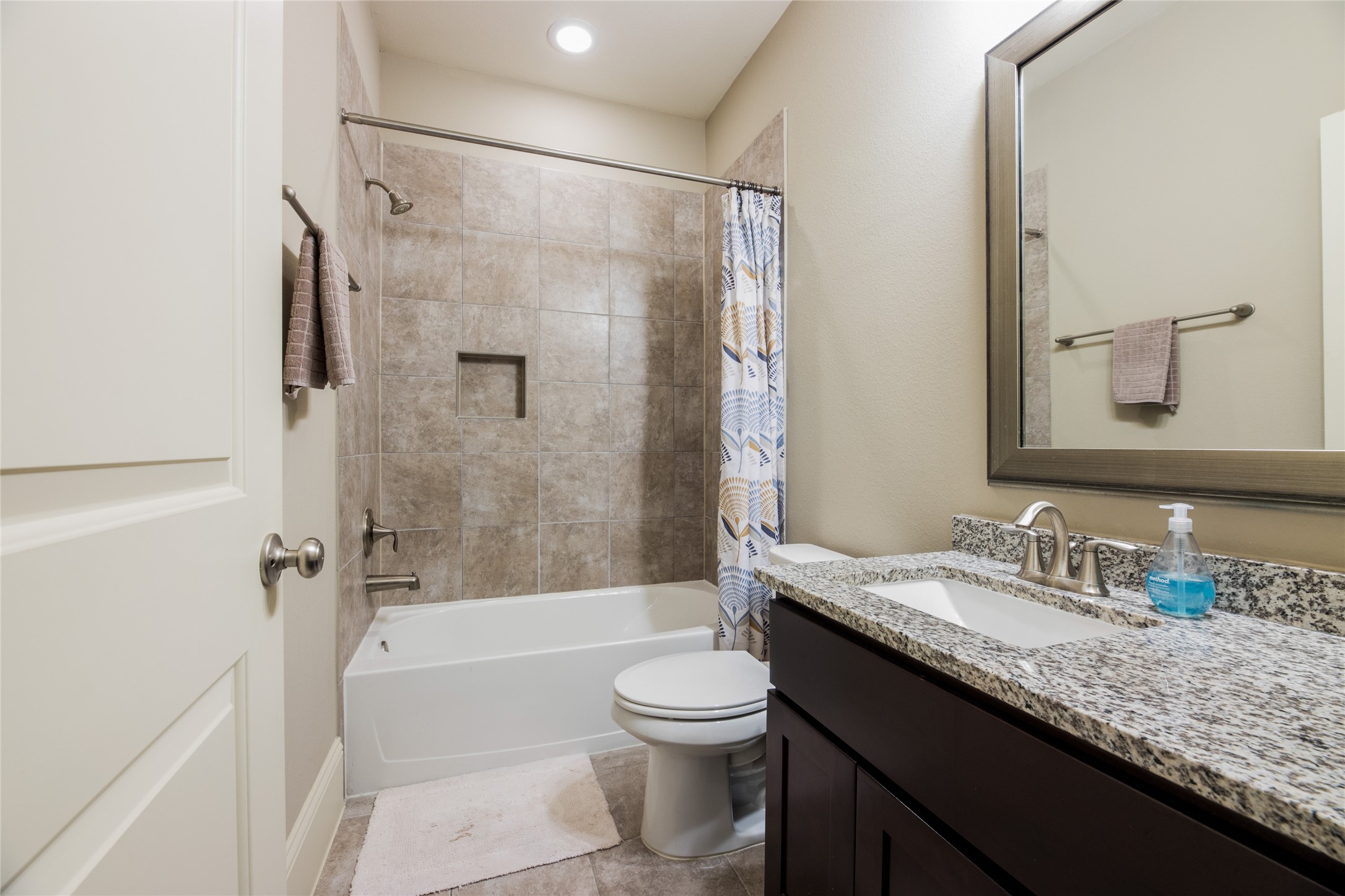 769 Waverly Street Houston, TX 77007 - Photo 7 of 35 a bathroom with a granite countertop tub toilet sink and mirror
