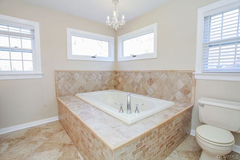 12907 Rivers Bend Road Chester, VA 23836 - Photo 24 of 43 Close-up of tile-surround master bath tub.