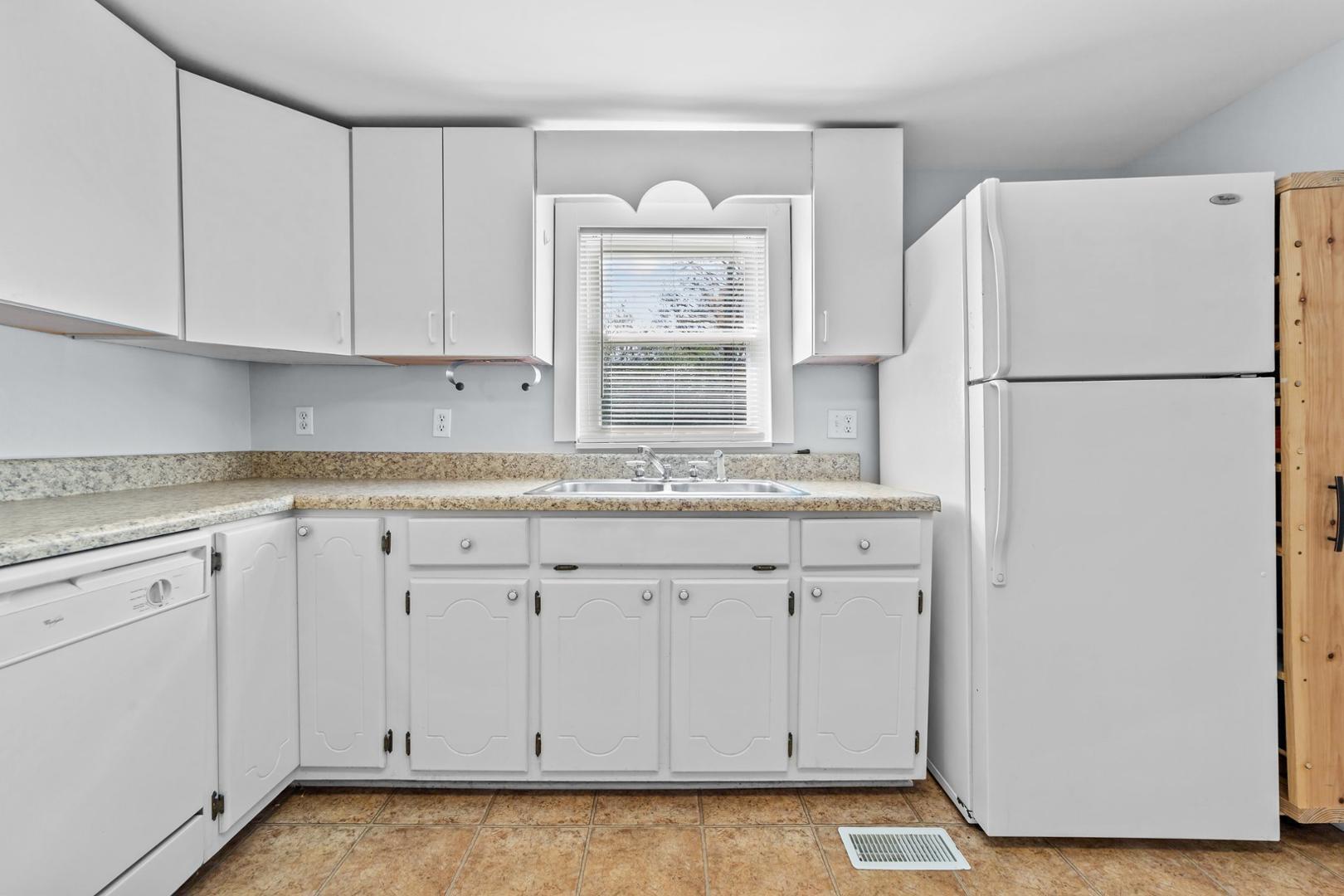 2005 Doc Nichols Road Durham, NC 27703 - Photo 27 of 37 a white refrigerator freezer sitting in a kitchen
