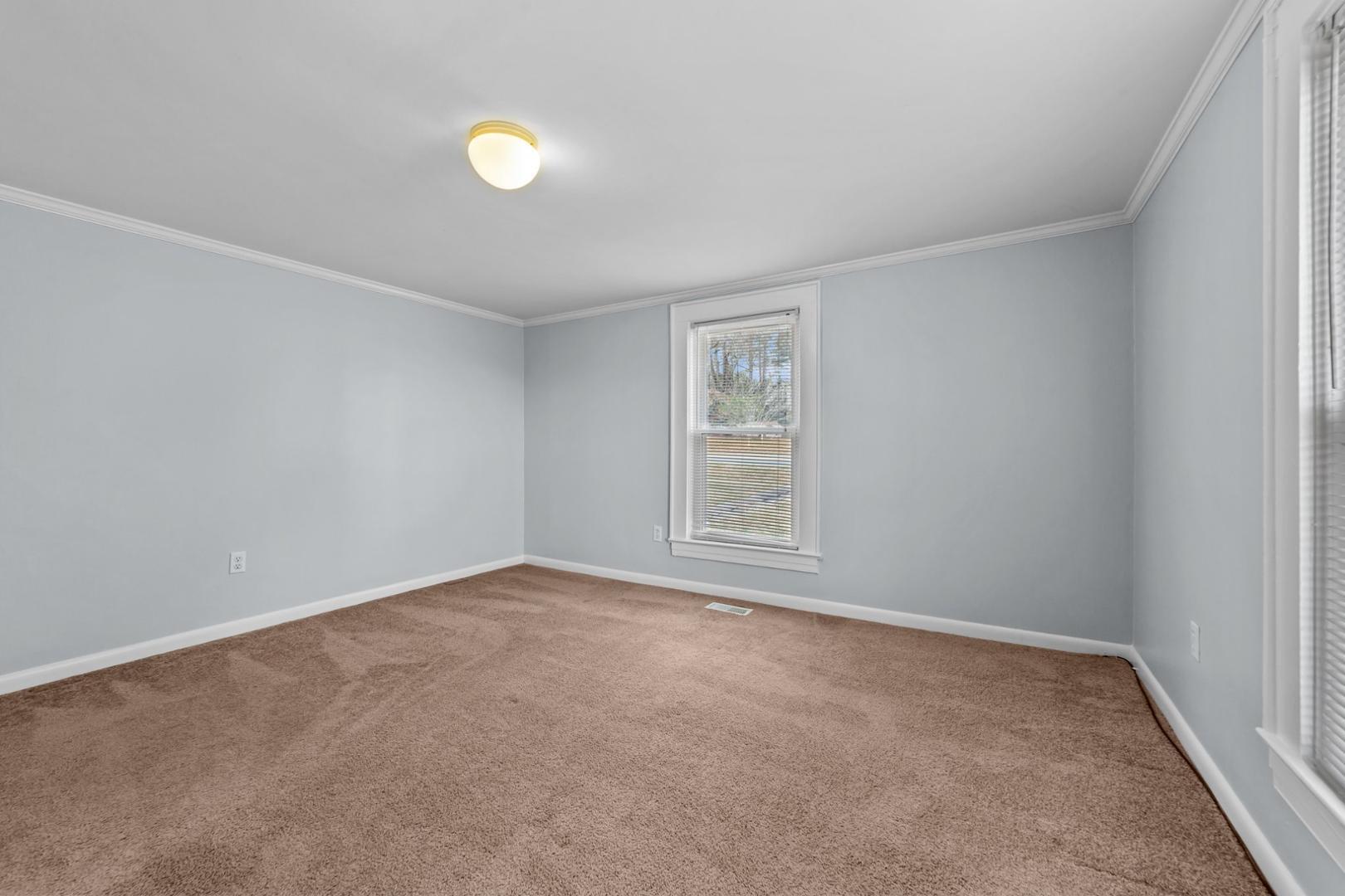 2005 Doc Nichols Road Durham, NC 27703 - Photo 34 of 37 an empty room with a window and a fan