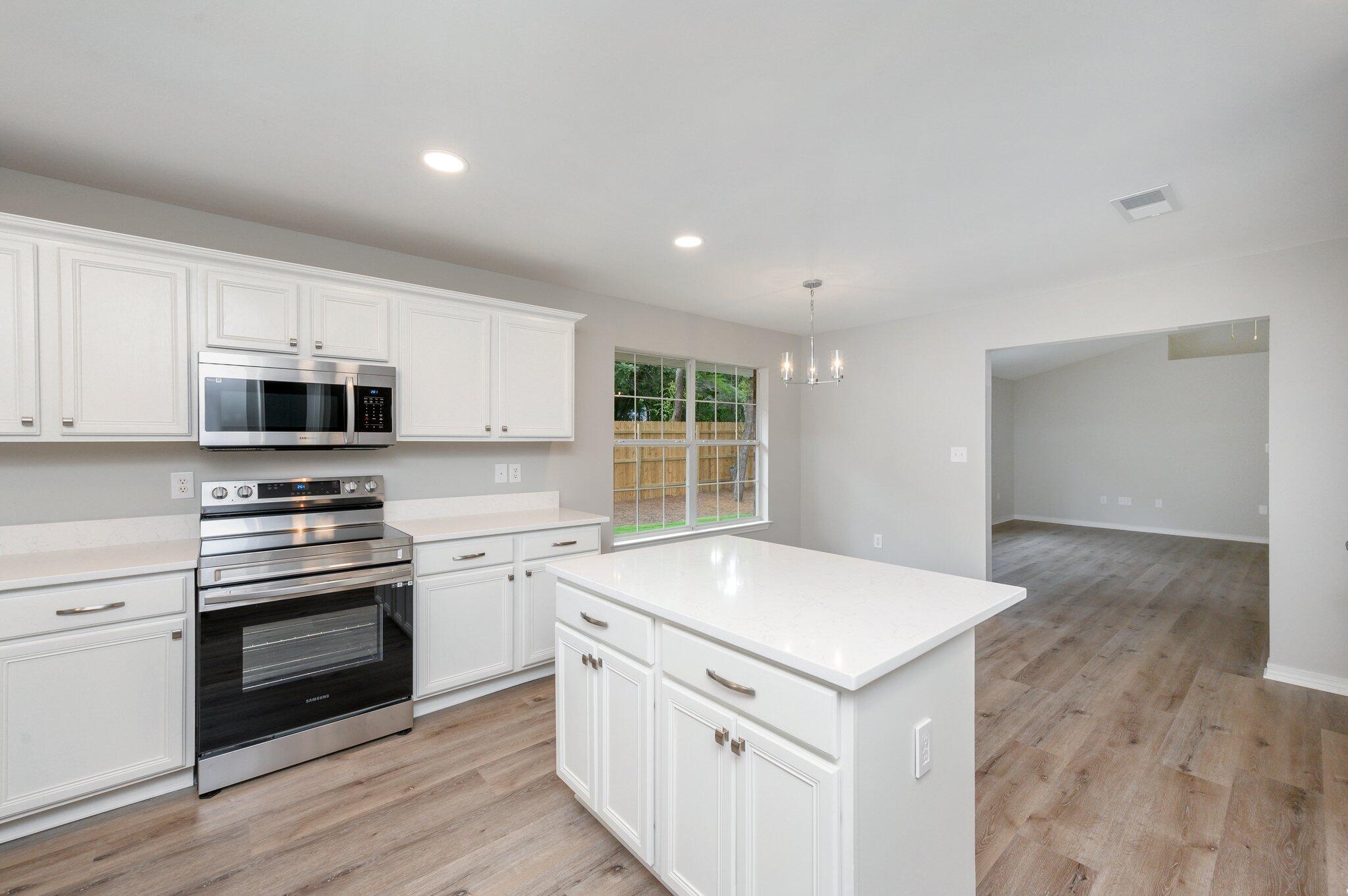 348 Beacon Way Santa Rosa Beach, FL 32459 - Photo 13 of 46 a kitchen with granite countertop white cabinets and white appliances