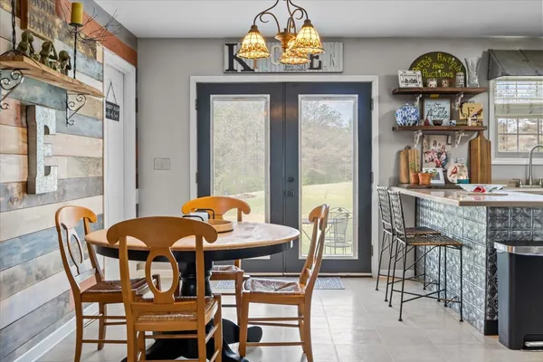 a view of a dining room with furniture and a window