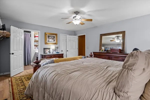 a bedroom with a large bed and a chandelier