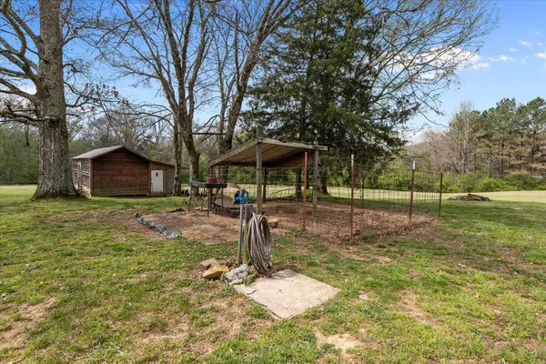 a backyard of a house with table and chairs