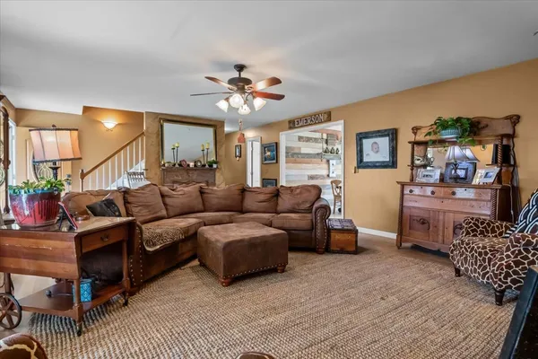 a living room with furniture and a chandelier