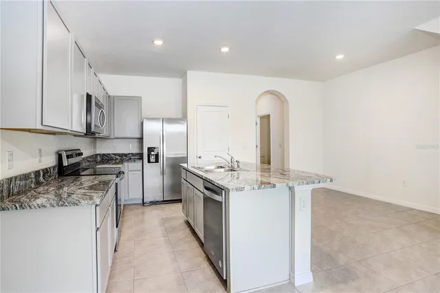 a kitchen with stainless steel appliances granite countertop a stove and a sink