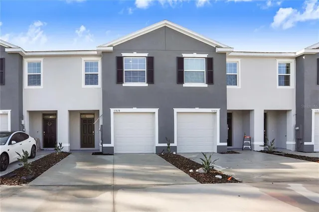 a front view of a house with a yard and garage