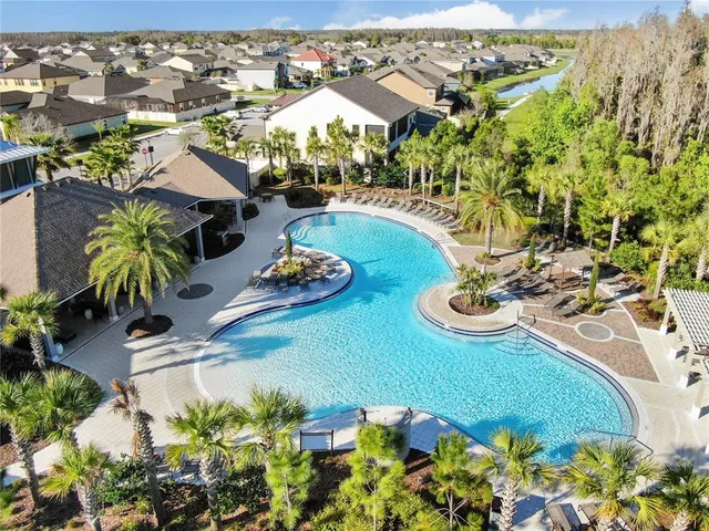 an aerial view of house with yard swimming pool and ocean view