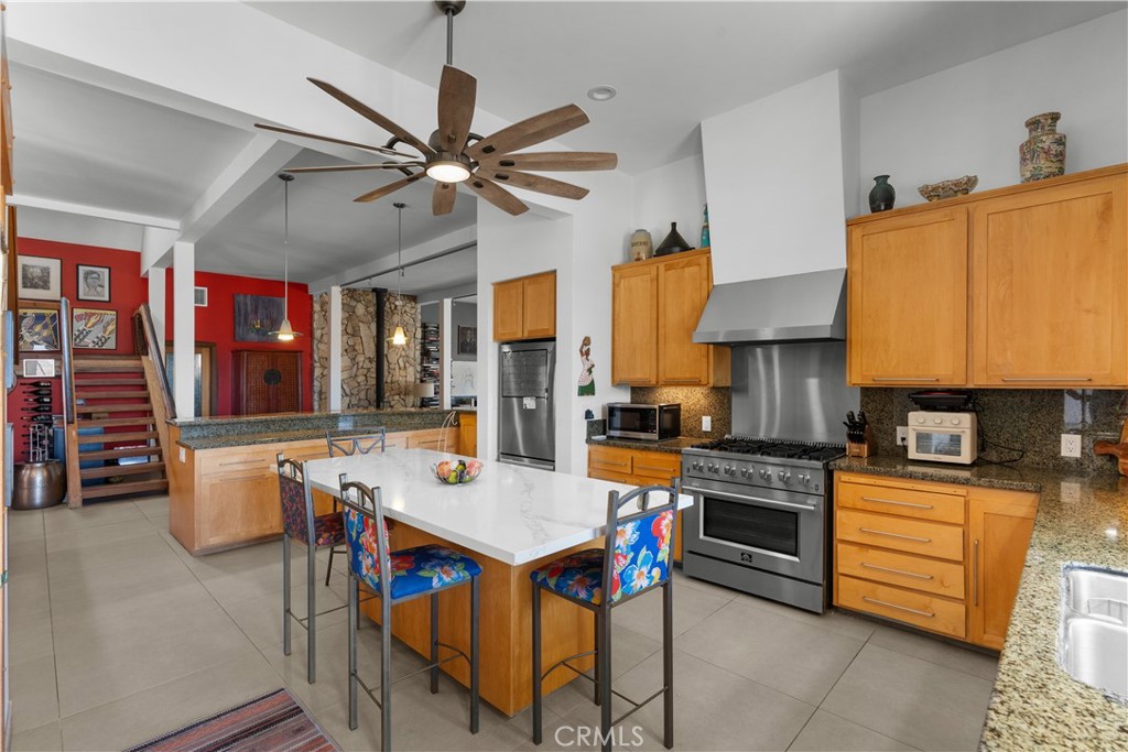 1010-1012 Upper Los Berros Road Nipomo, CA 93444 - Photo 14 of 75 a open kitchen with stainless steel appliances granite countertop a stove top oven a refrigerator a dining table and chairs with wooden floor