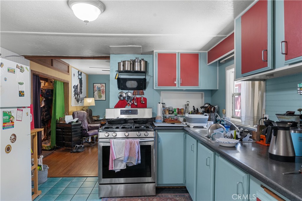 1010-1012 Upper Los Berros Road Nipomo, CA 93444 - Photo 61 of 75 a kitchen with stainless steel appliances granite countertop a stove and cabinets