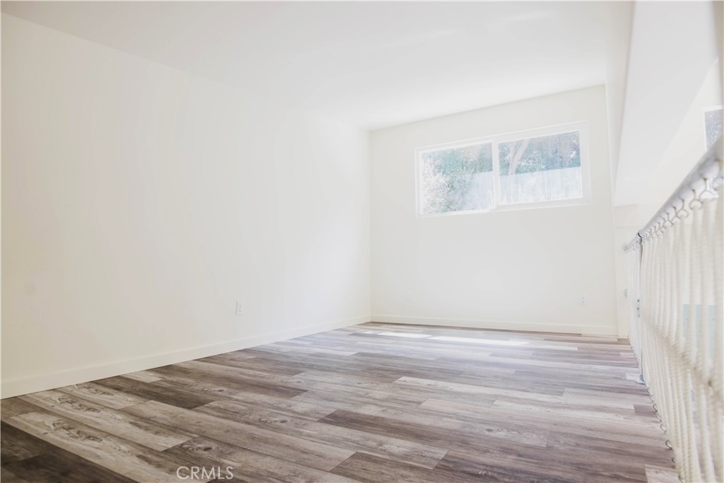 1010-1012 Upper Los Berros Road Nipomo, CA 93444 - Photo 74 of 75 a view of an empty room with wooden floor and a window