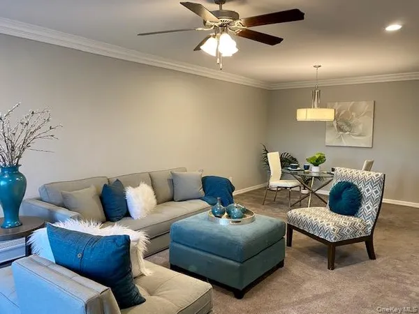 a living room with furniture and a chandelier