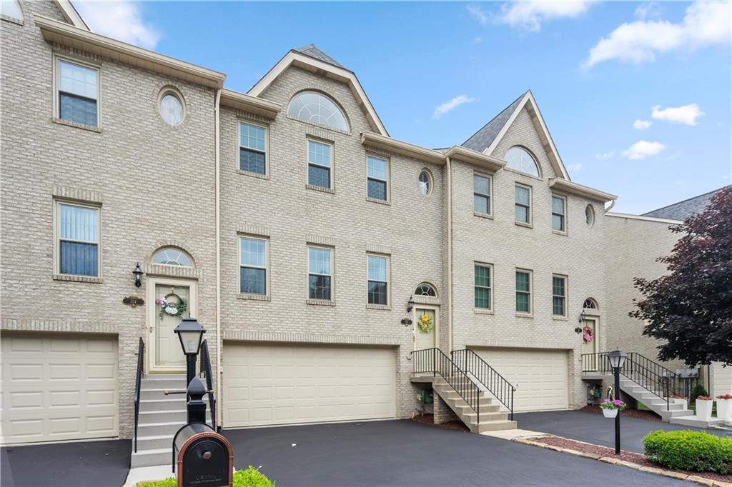 a front view of a house with parking