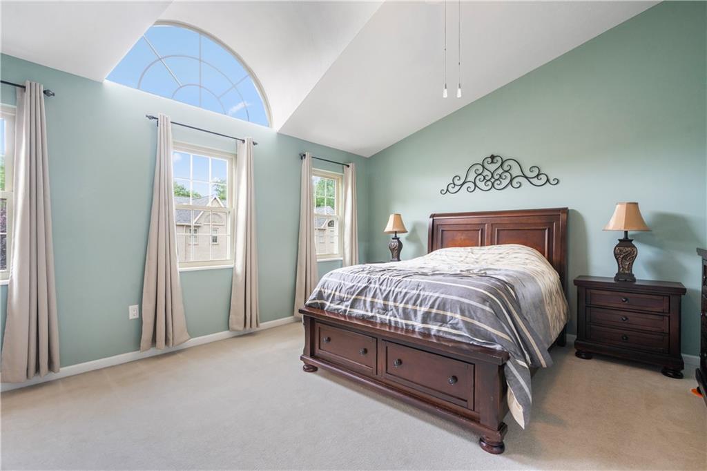 122 Terra Drive McKees Rocks, PA 15136 - Photo 17 of 28 a spacious bedroom with a bed and a lamp