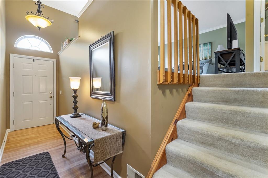 122 Terra Drive McKees Rocks, PA 15136 - Photo 2 of 28 a view of a hallway with couches and large windows with wooden floor