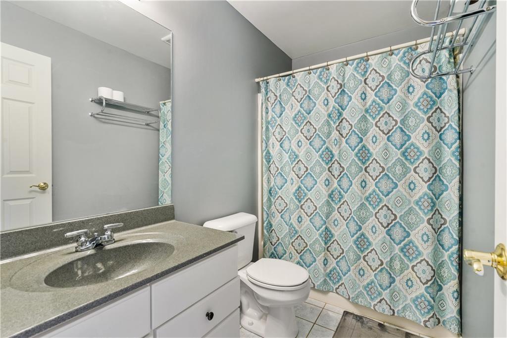 122 Terra Drive McKees Rocks, PA 15136 - Photo 23 of 28 a bathroom with a granite countertop sink and a mirror