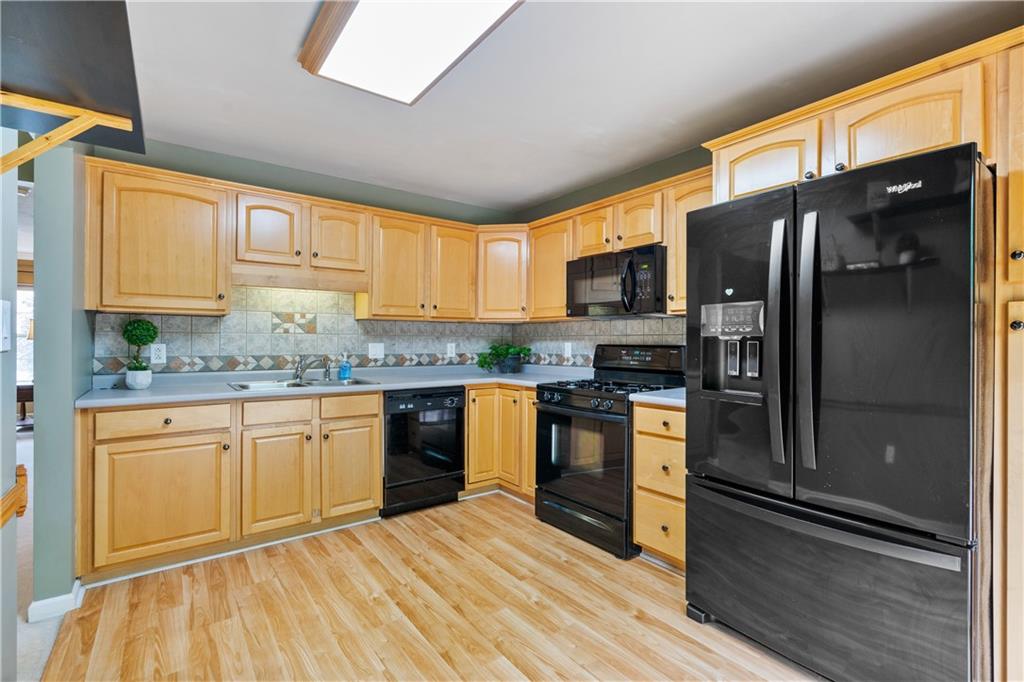 122 Terra Drive McKees Rocks, PA 15136 - Photo 8 of 28 a kitchen with granite countertop stainless steel appliances and wooden cabinets