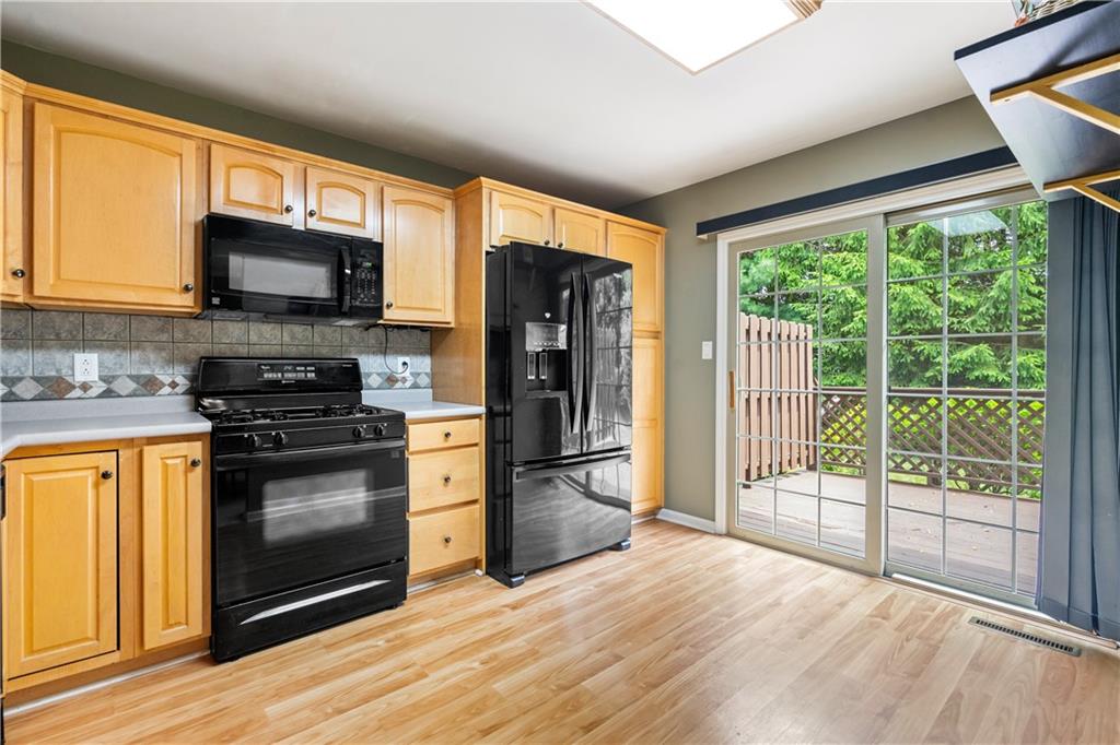 122 Terra Drive McKees Rocks, PA 15136 - Photo 9 of 28 a kitchen with stainless steel appliances granite countertop a stove refrigerator and microwave