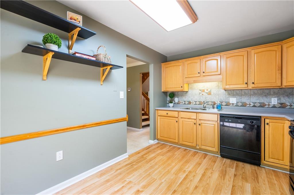 122 Terra Drive McKees Rocks, PA 15136 - Photo 10 of 28 a kitchen with granite countertop a refrigerator and wooden cabinets