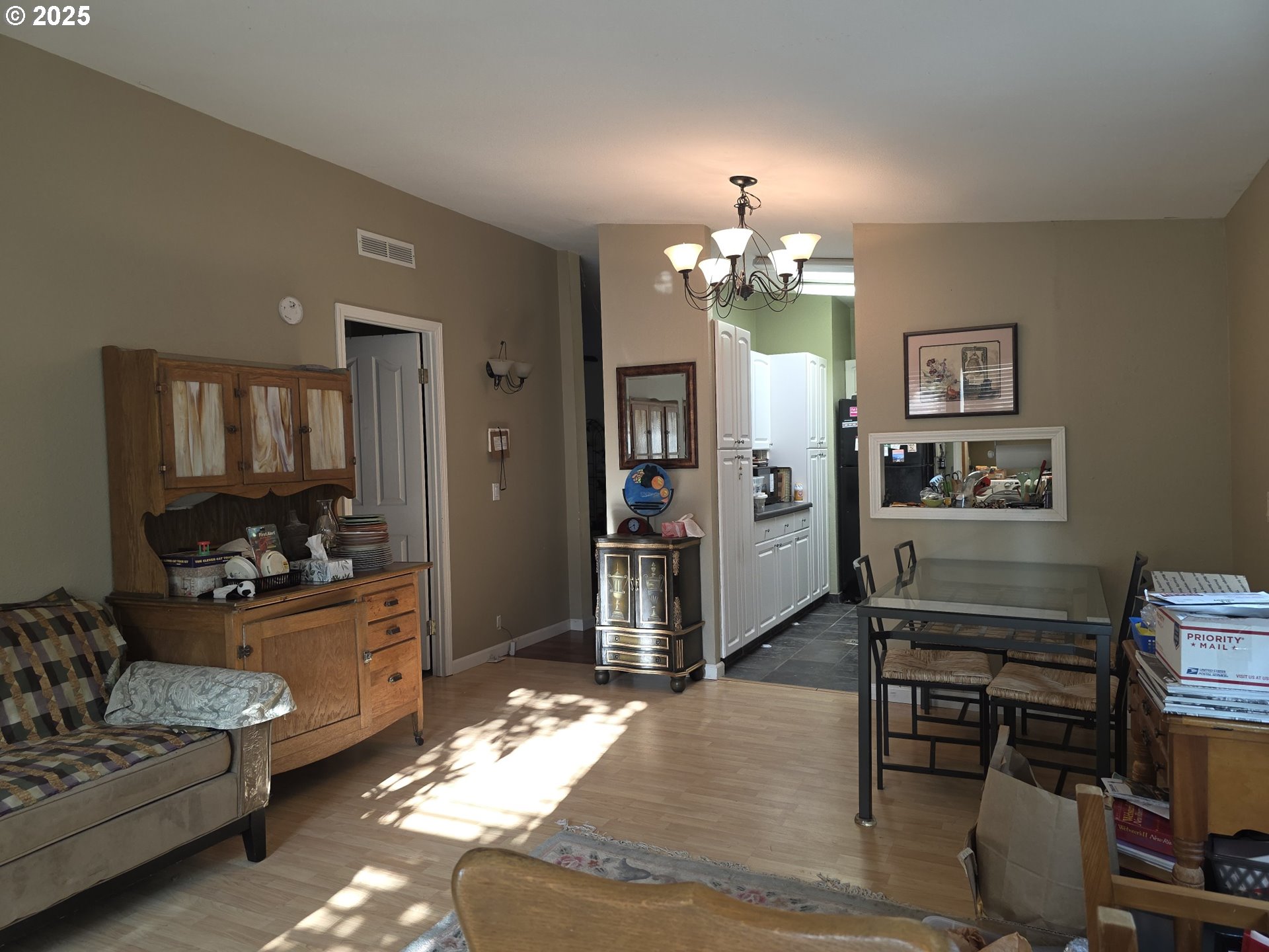 4808 Southeast 134th Drive Portland, OR 97236 - Photo 12 of 15 a living room with furniture and a chandelier