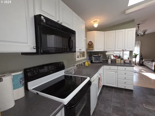 a kitchen with stainless steel appliances a refrigerator and cabinets