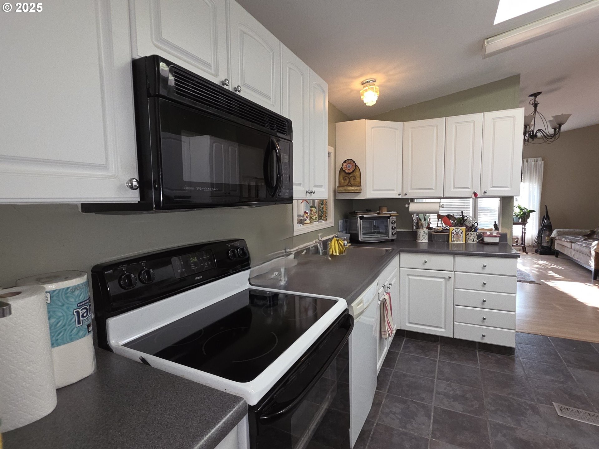 4808 Southeast 134th Drive Portland, OR 97236 - Photo 6 of 15 a kitchen with granite countertop a stove sink and cabinets