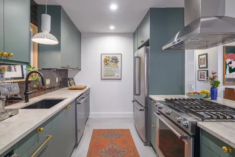 a kitchen that has a sink and a stove