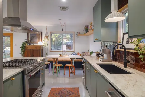 a kitchen with a sink stove and cabinets