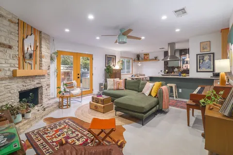 a living room with furniture fireplace and a window