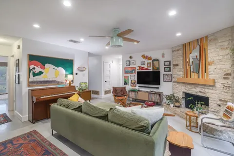 a living room with fireplace furniture and a flat screen tv